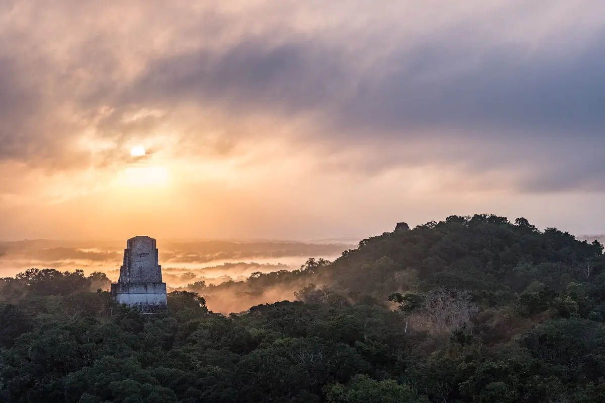 Sunrise over the forest with a temple top